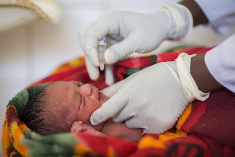 African experts call for urgent action to reduce maternal deaths Oral polio vaccine is administered to a one-day old child in Ethiopia.